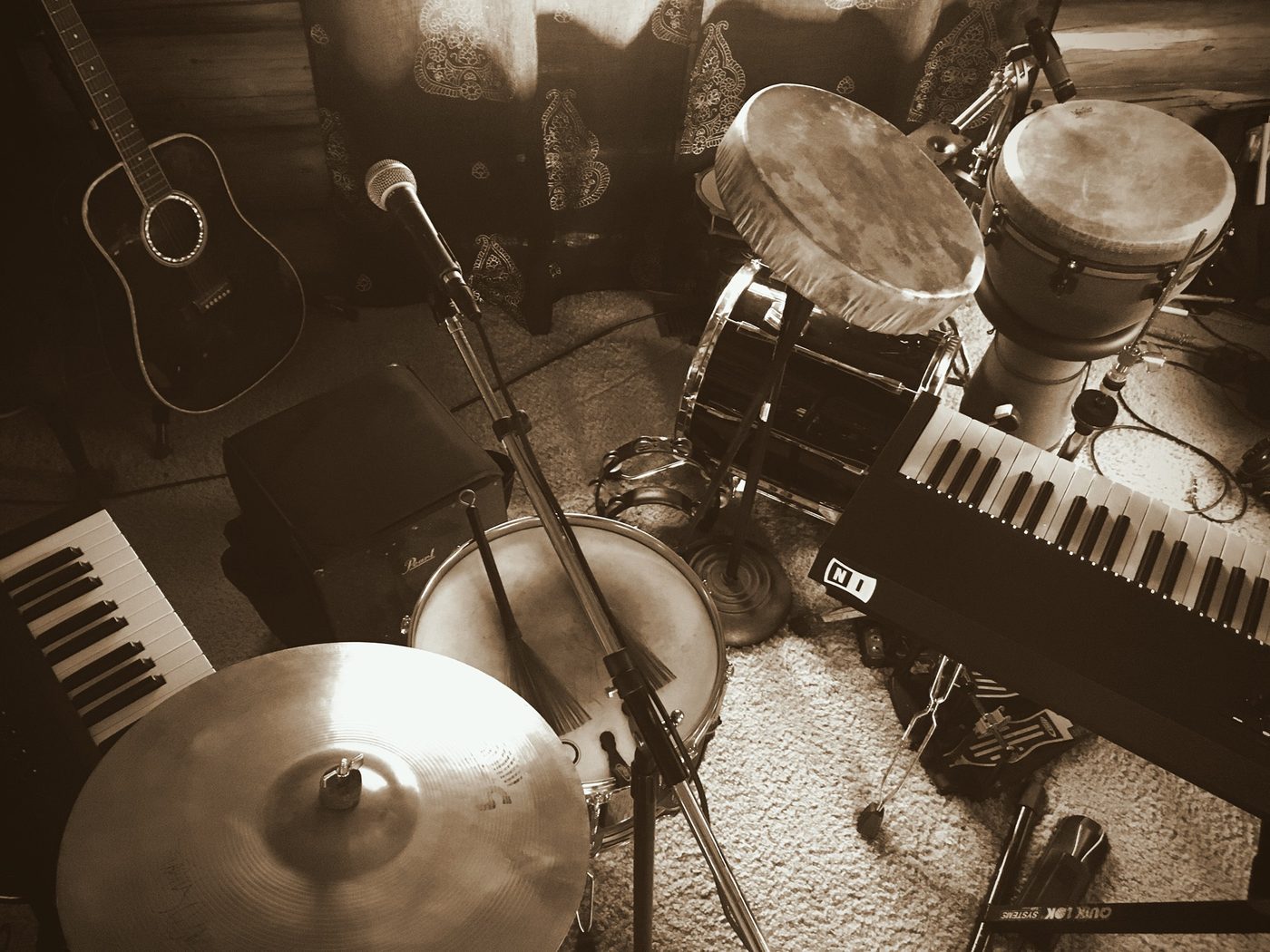 Sepia-toned studio setup with drums and guitar